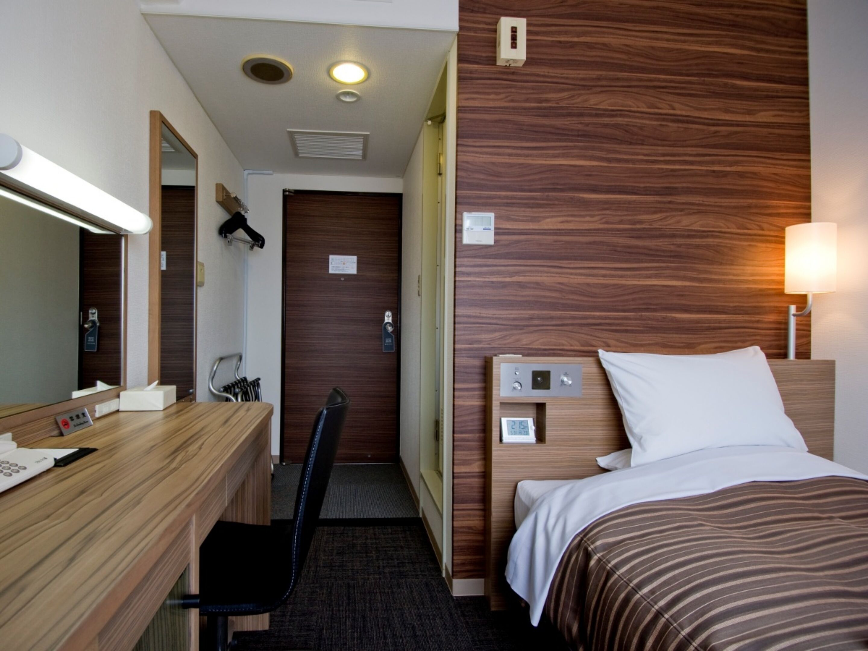 Desk, iron/ironing board, bed sheets