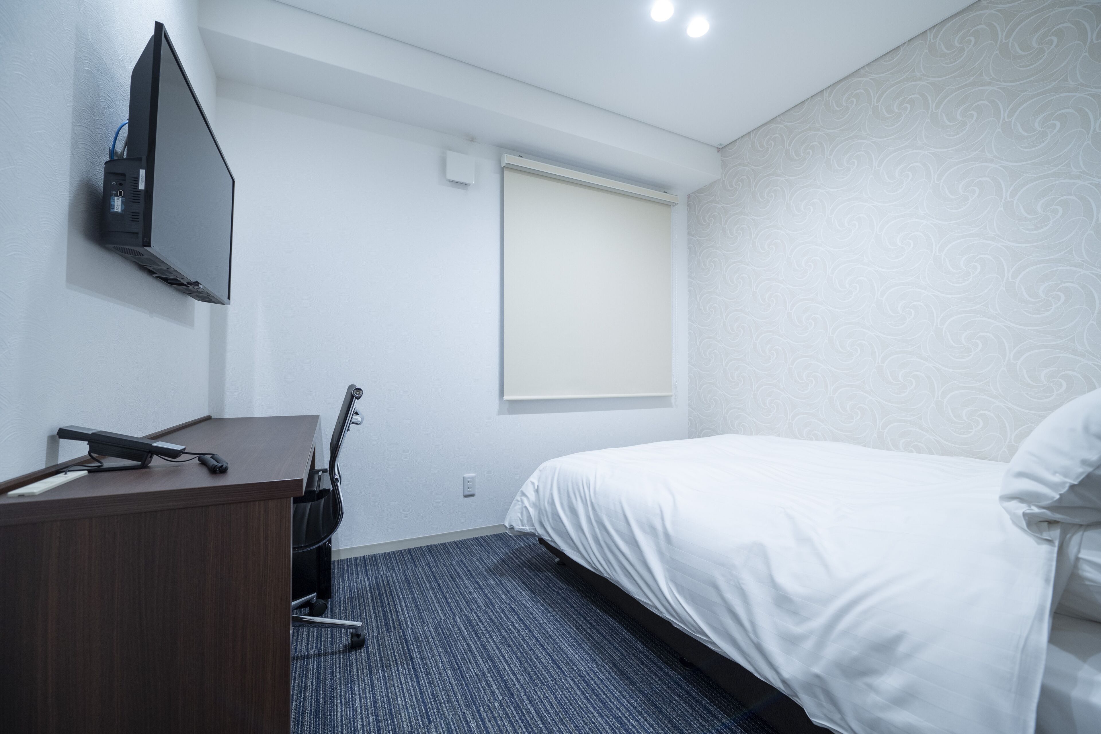 Desk, iron/ironing board, bed sheets