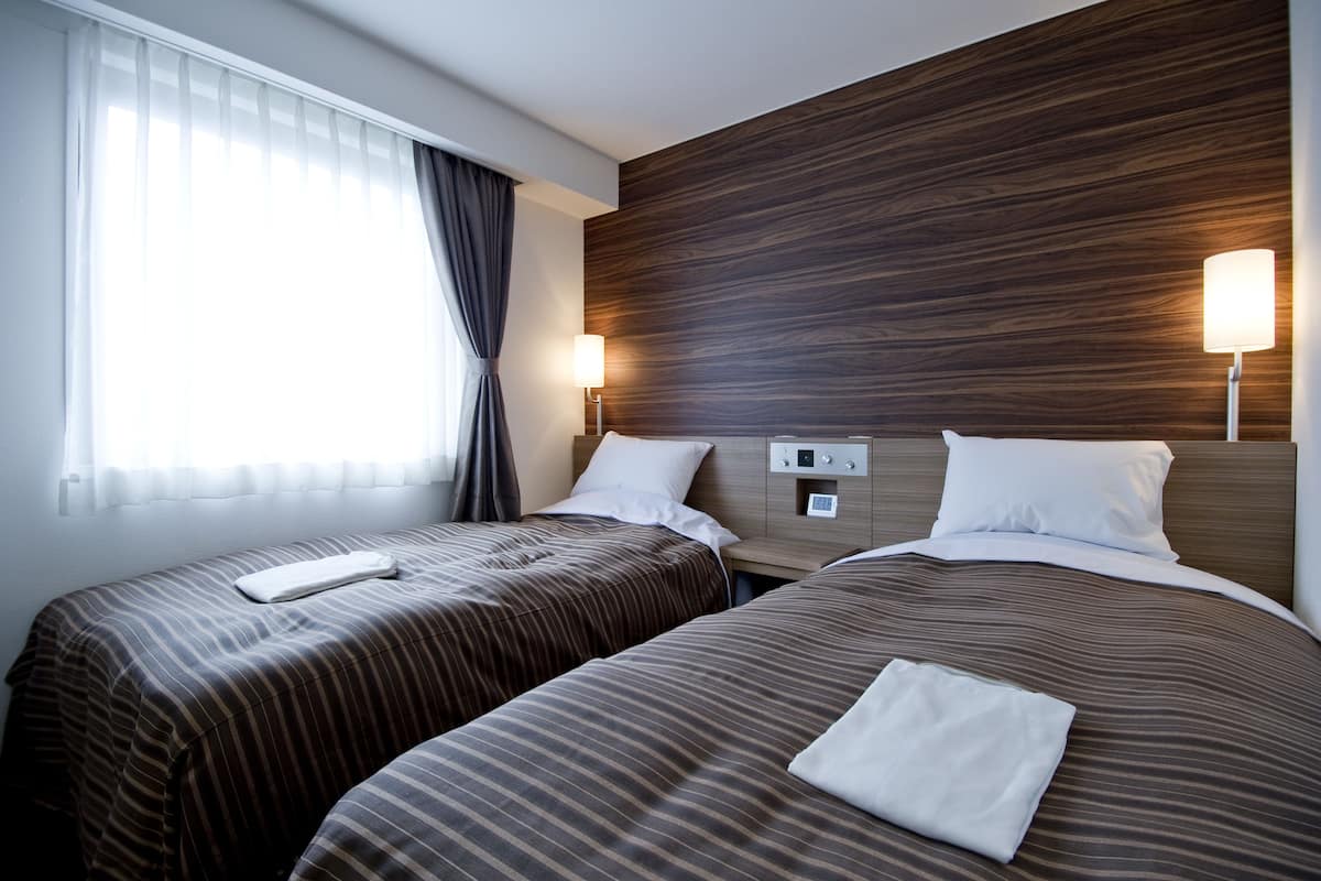 desk, iron/ironing board, bed sheets