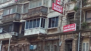 A building with multiple balconies and a sign reading "SANGAM GUEST HOUSE". - Sangam Guest House (Mumbai)