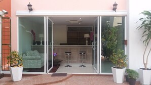 A hotel entrance with a glass door, a reception desk, and potted plants. - Parkview Ratchaprarop (Bangkok)