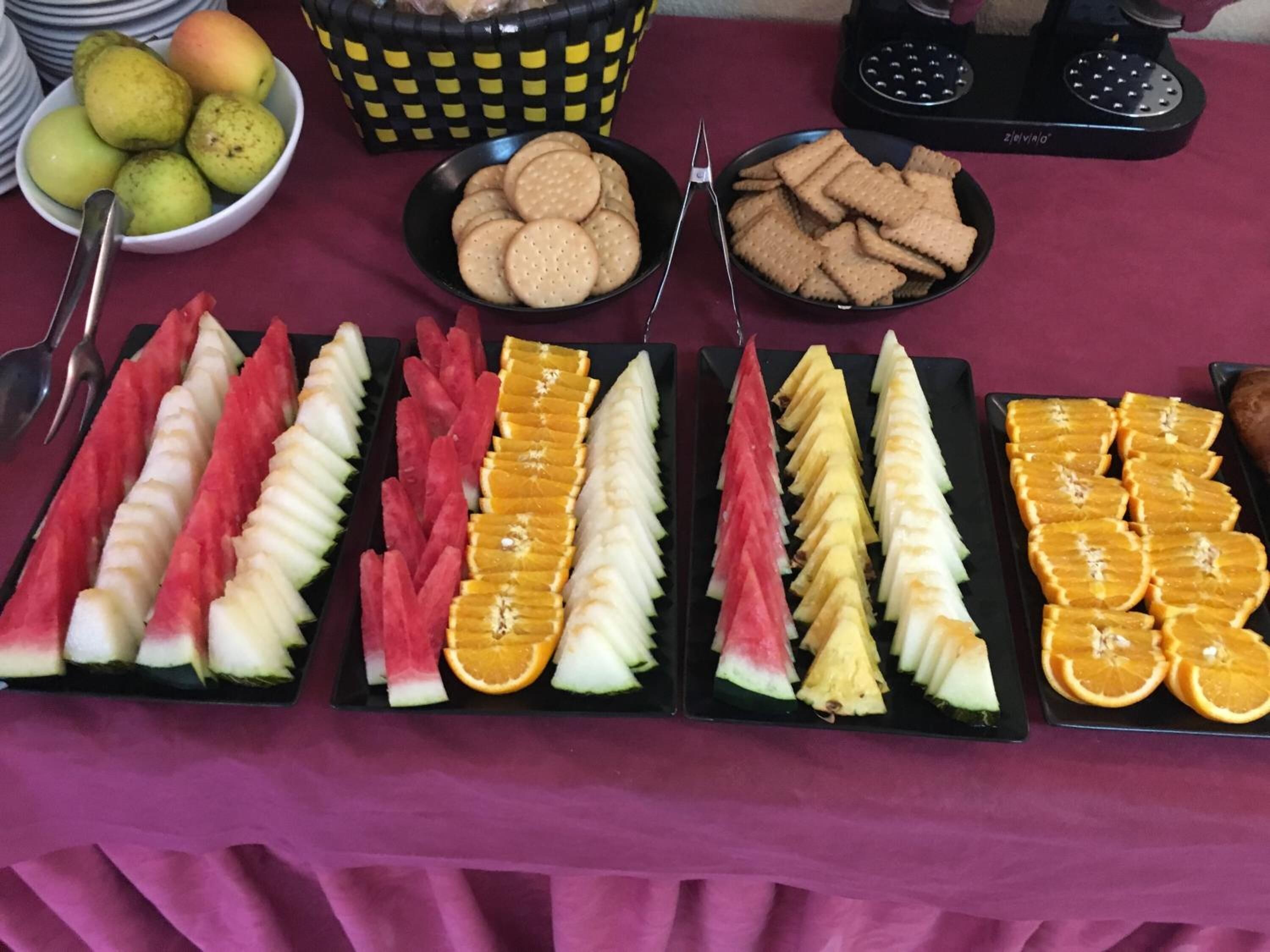 Un tavolo con una varietà di frutta e cracker.