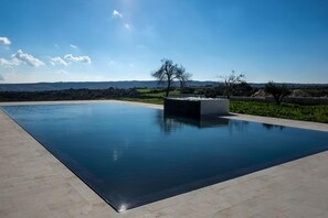 Seasonal outdoor pool, an infinity pool, pool loungers