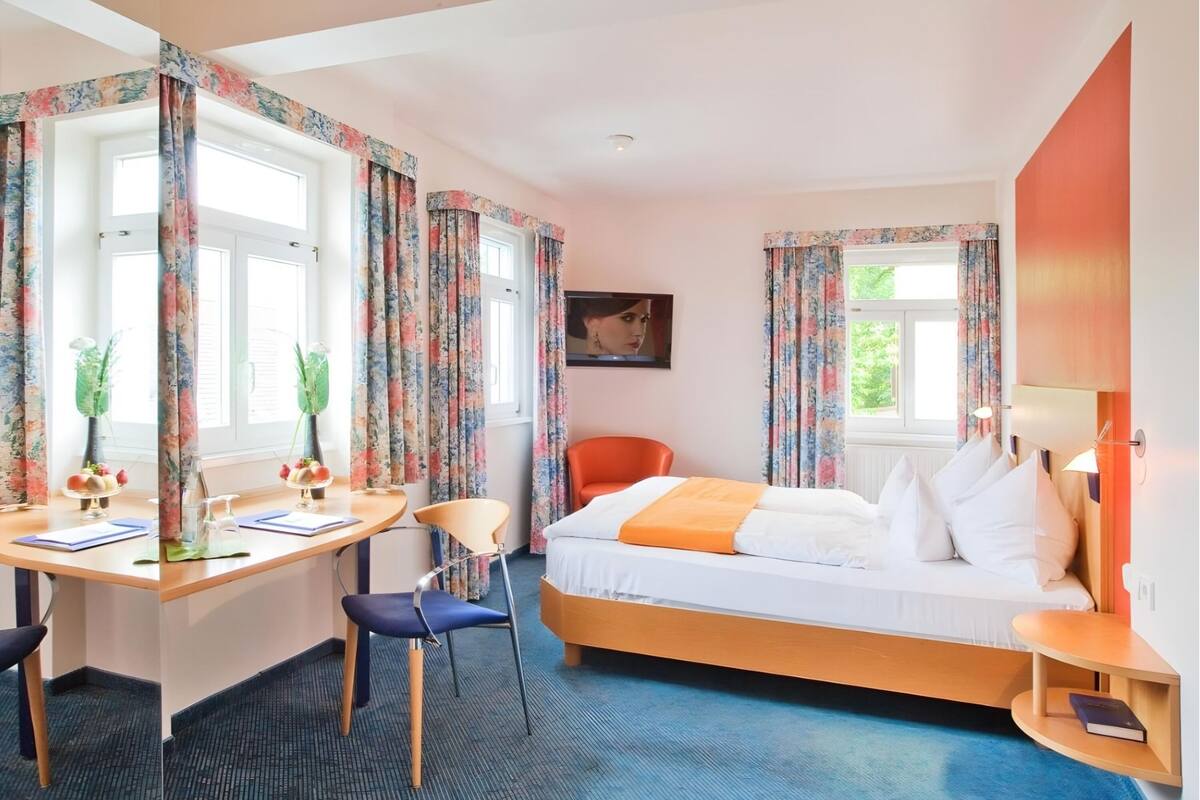 hypo-allergenic bedding, desk, laptop workspace, blackout curtains