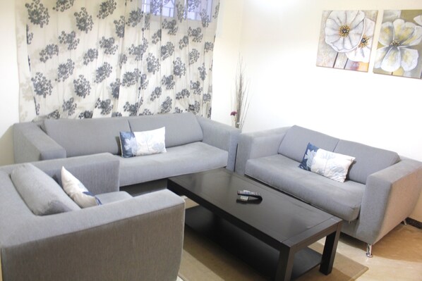 City Apartment, 1 King Bed (Rue Arajaa, 2nd floor) | Living room | Flat-screen TV