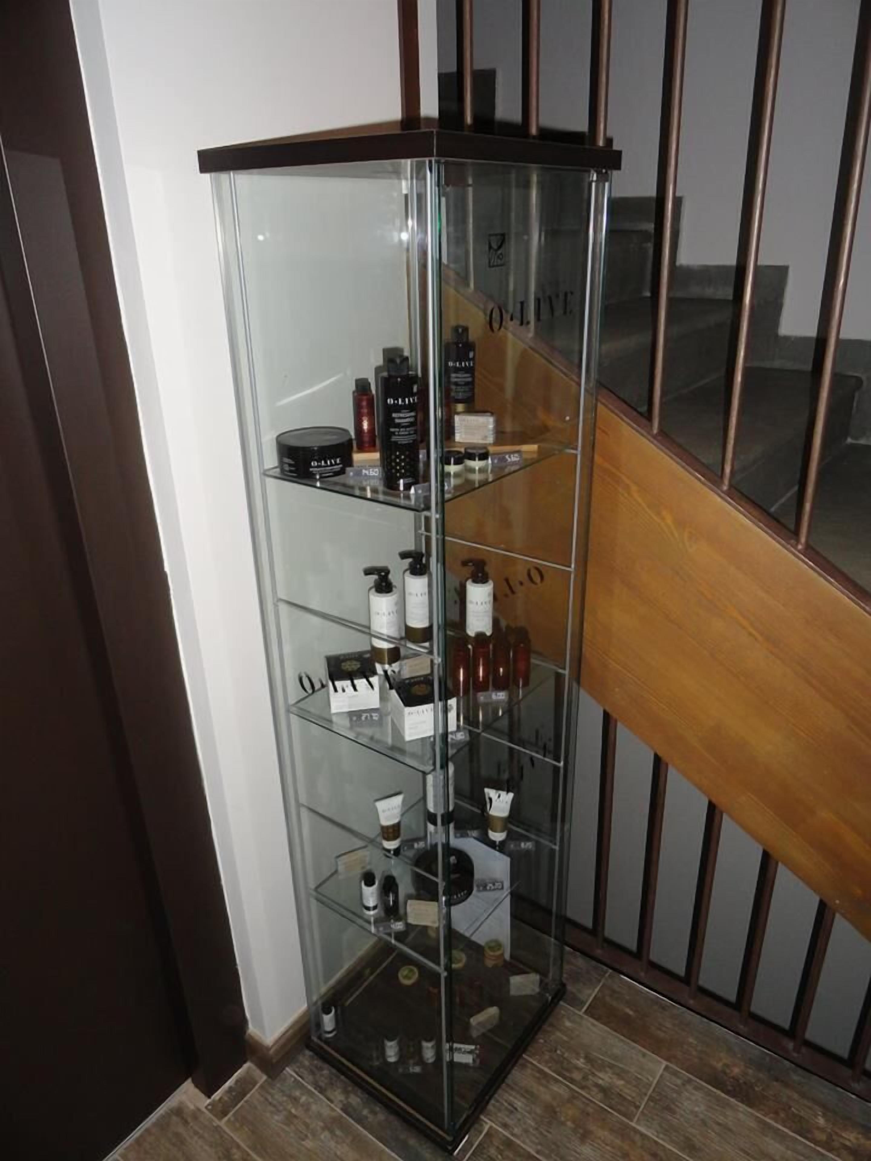A corner display cabinet with various skincare products.