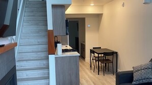 The loft, with Kitchenette (Lower level) | Living area | Flat-screen TV - Pacific Point Market & Suites (Powell River)