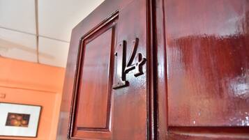 A wooden door with a number '1' and a small square cutout.