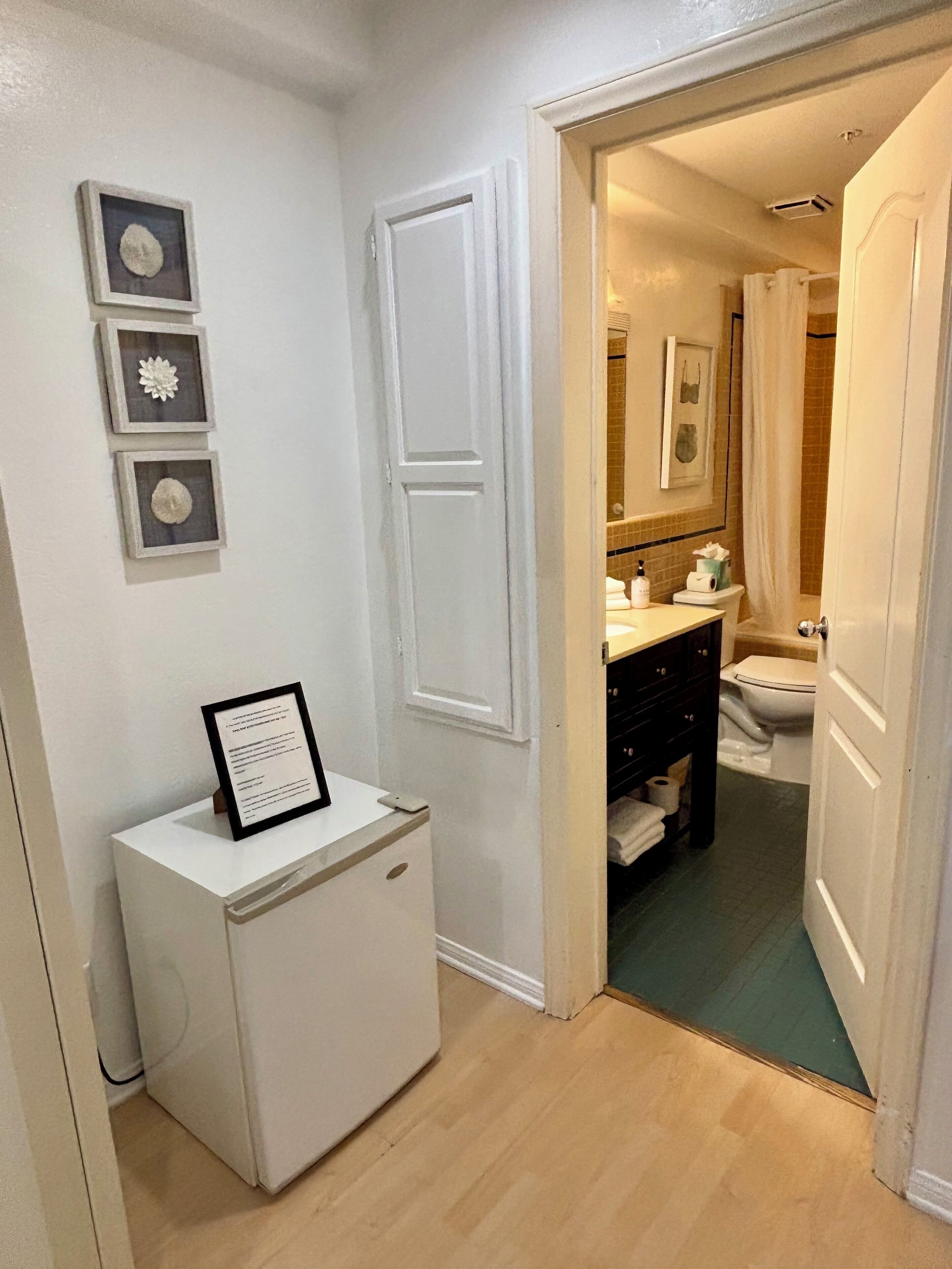 A compact bathroom with a toilet, sink, and shower area.