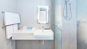 A modern bathroom with a white sink, mirror, and shower. - Holiday Inn Express Brisbane Central by IHG (Spring Hill)