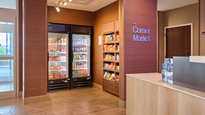 A corner market with refrigerated display cases and snack shelves. - Fairfield Inn & Suites by Marriott Philadelphia Horsham (Willow Grove)