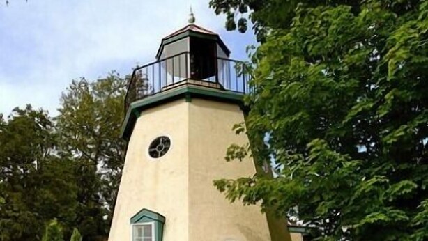 A unique, tower-shaped building with a sign reading "Harbor Inn House".