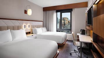 Premium bedding, pillow-top beds, desk, laptop workspace