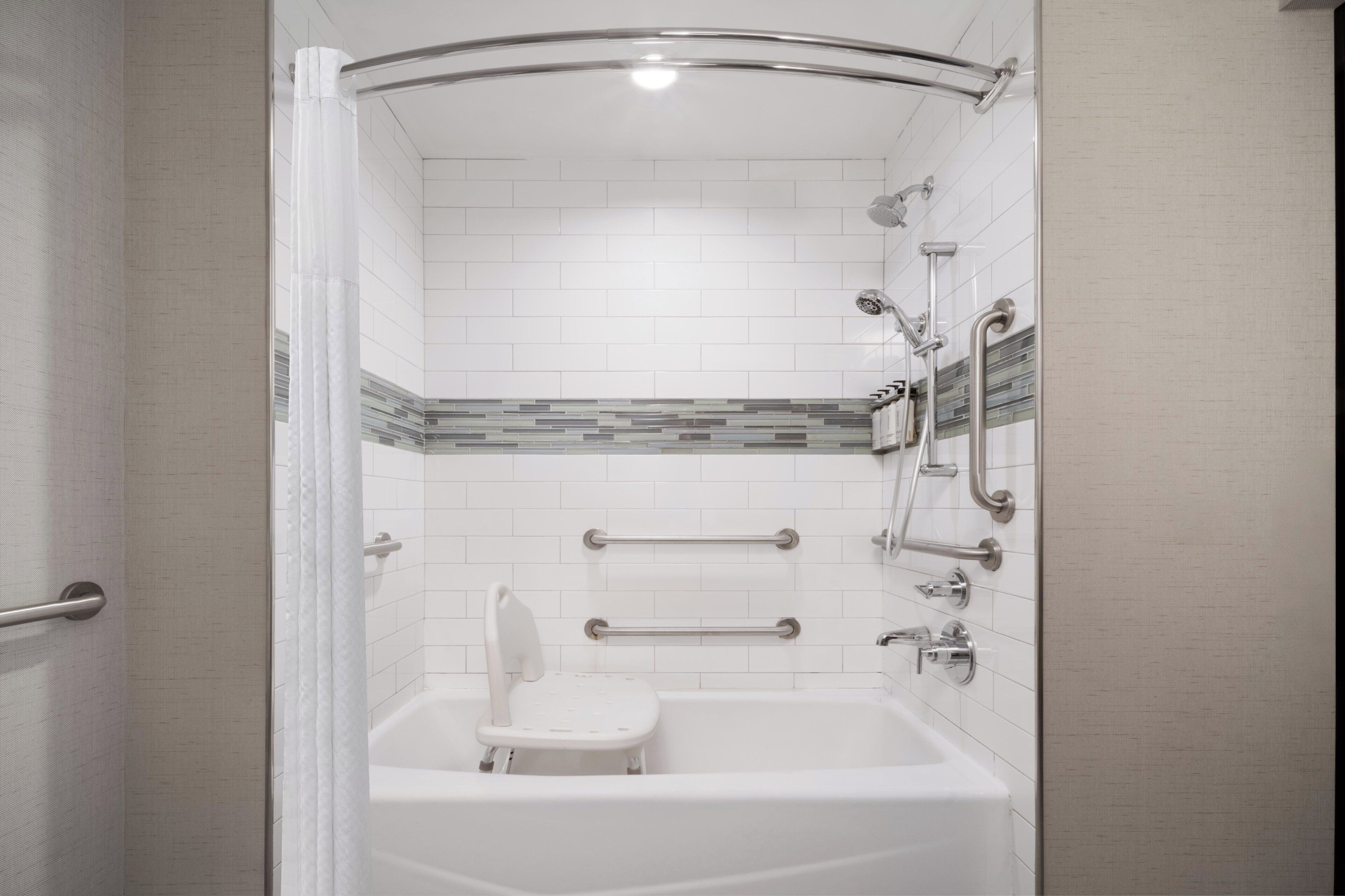 A bathroom with a bathtub, a shower area, and a toilet.