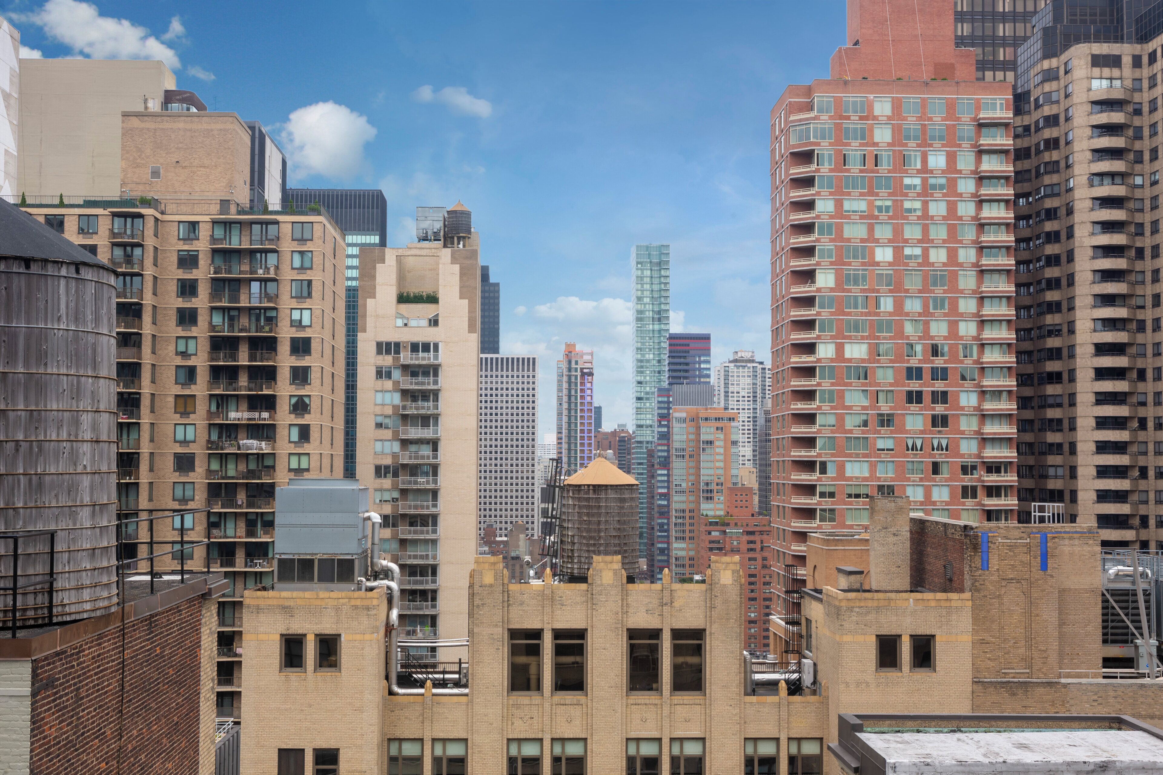 A cityscape with various high-rise buildings, including residential and commercial structures.