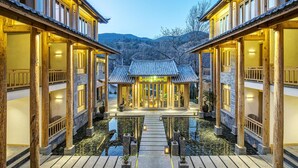 A traditional building with a central courtyard, wooden pillars, and a tiled roof.