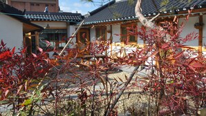A traditional Japanese-style building with a tiled roof and wooden structures. - Tosarang Guesthouse (Jeonju)