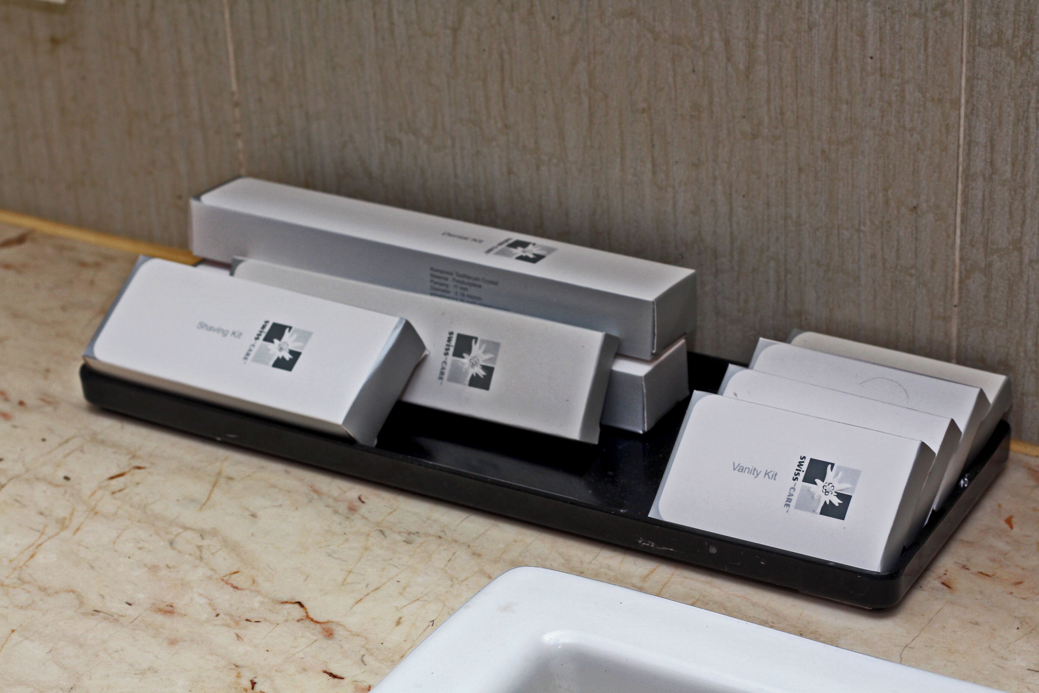 A tray with several white boxes, some labeled "Vanity Kit" and others with different labels.