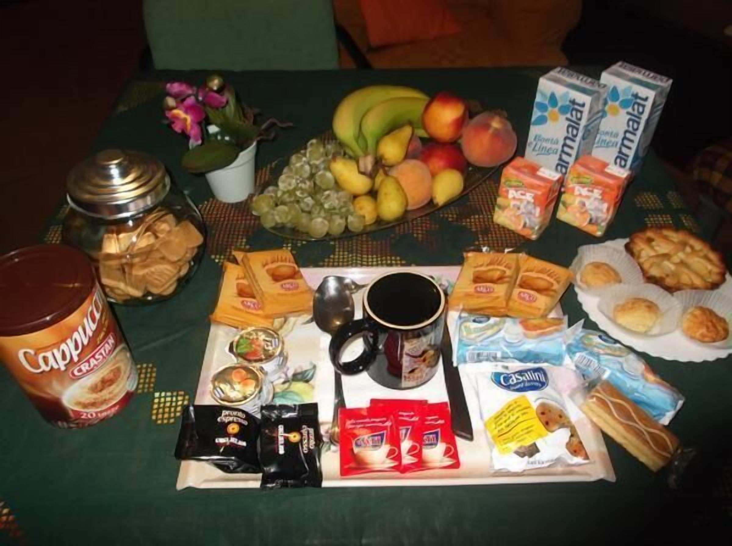 A table with various food items, including fruits, packaged snacks, and condiments.