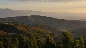 A panoramic view of a mountainous landscape with a clear sky.