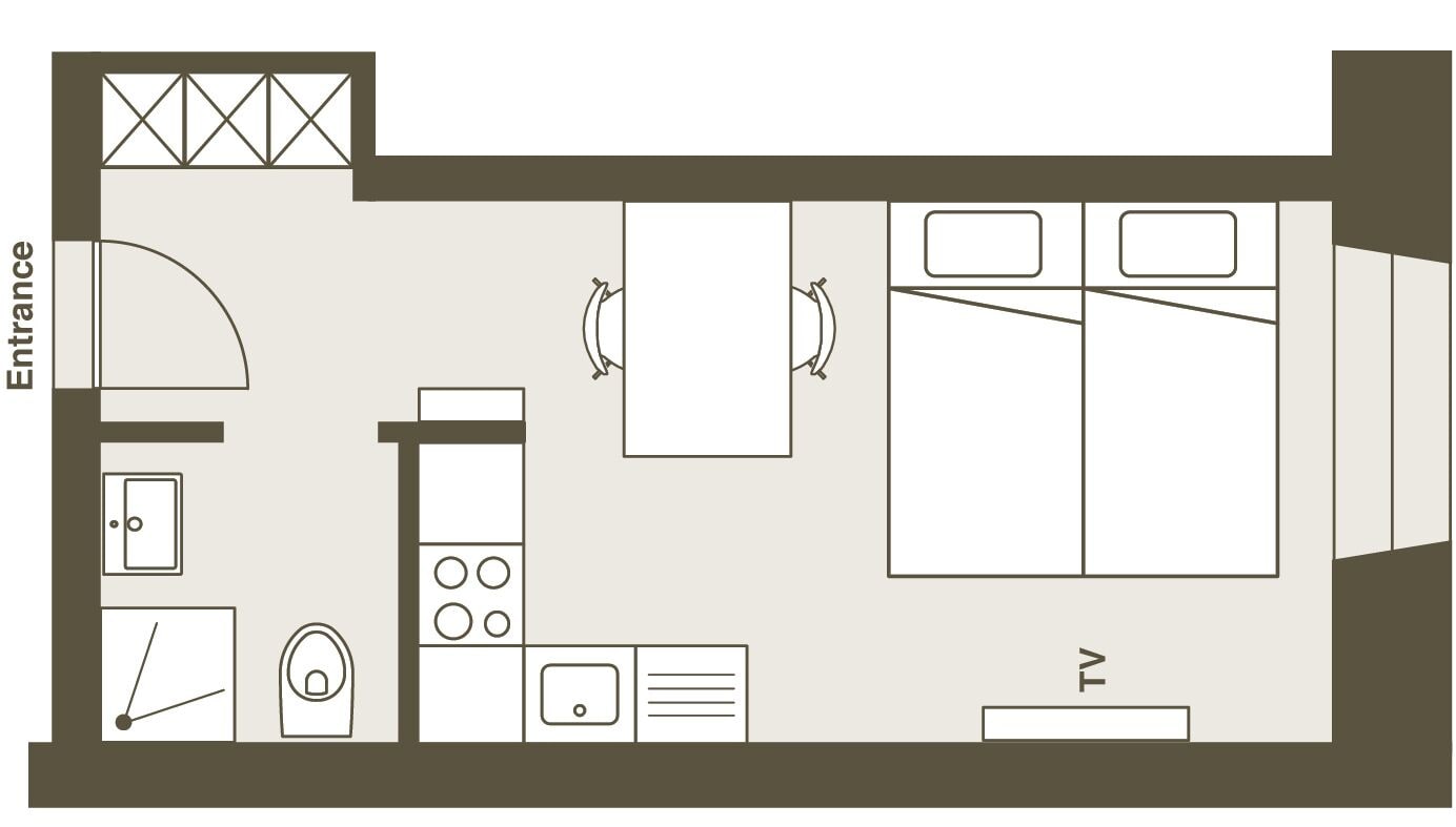 A hotel room layout with an entrance, a bathroom, a kitchenette, a TV, and a bed.