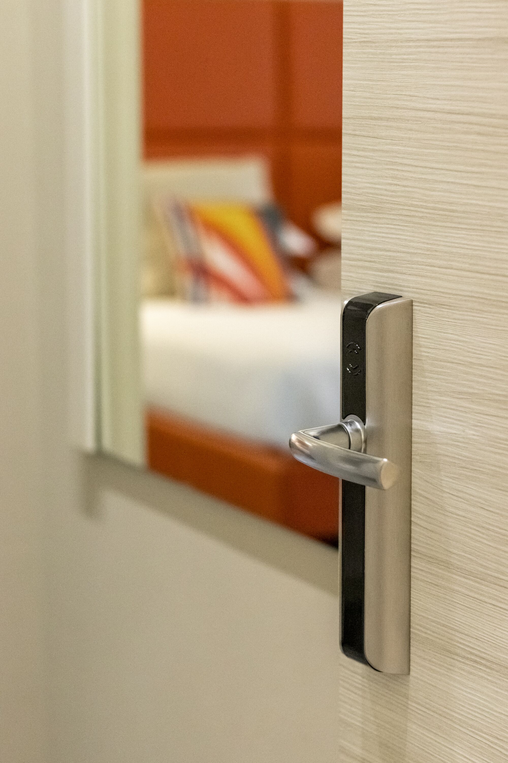 A modern door with a metallic handle and a keyhole.