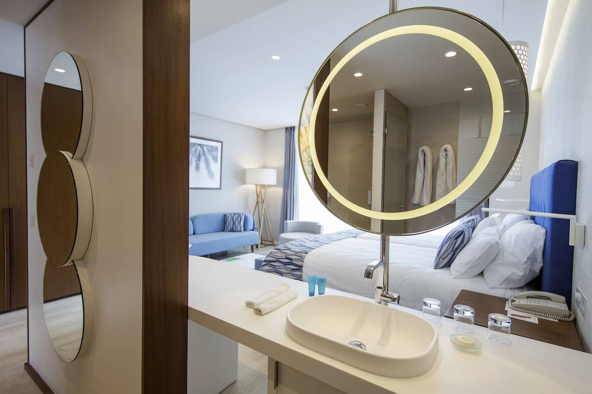 deluxe double room | bathroom | shower, eco-friendly toiletries, hair dryer, slippers