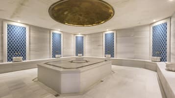 Bathroom features a central sink, polished floor, and large windows with diamond-patterned glass.