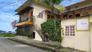 Stunning two-story apartments with a balcony and staircase, set amidst lush greenery and a tropical atmosphere.