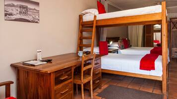 A bunk bed room with a desk, chair, and a mirror.