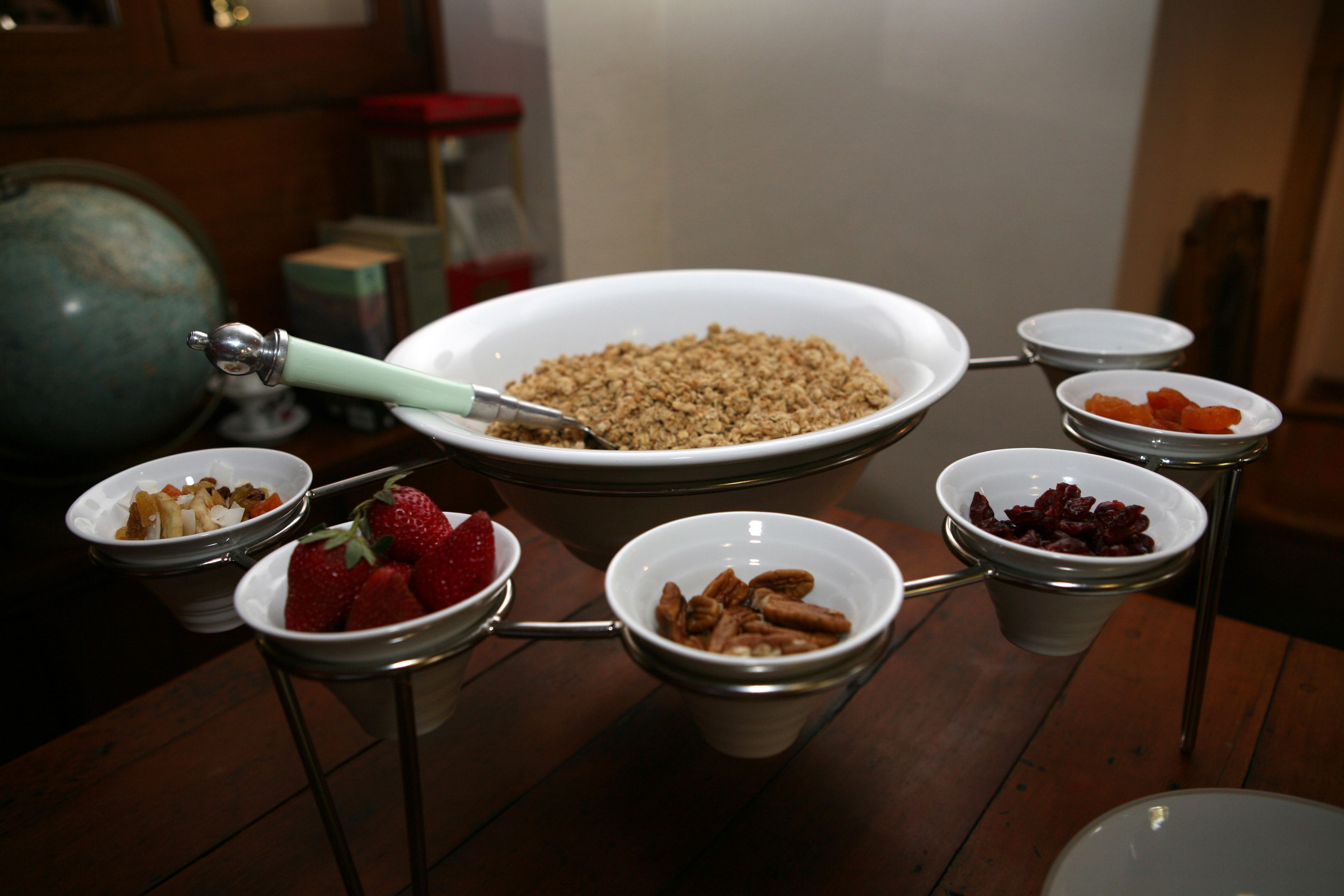 A buffet table with various food items in bowls and a large bowl in the center.