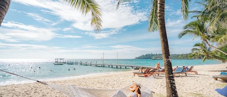 On the beach, sun-loungers, beach umbrellas, beach towels