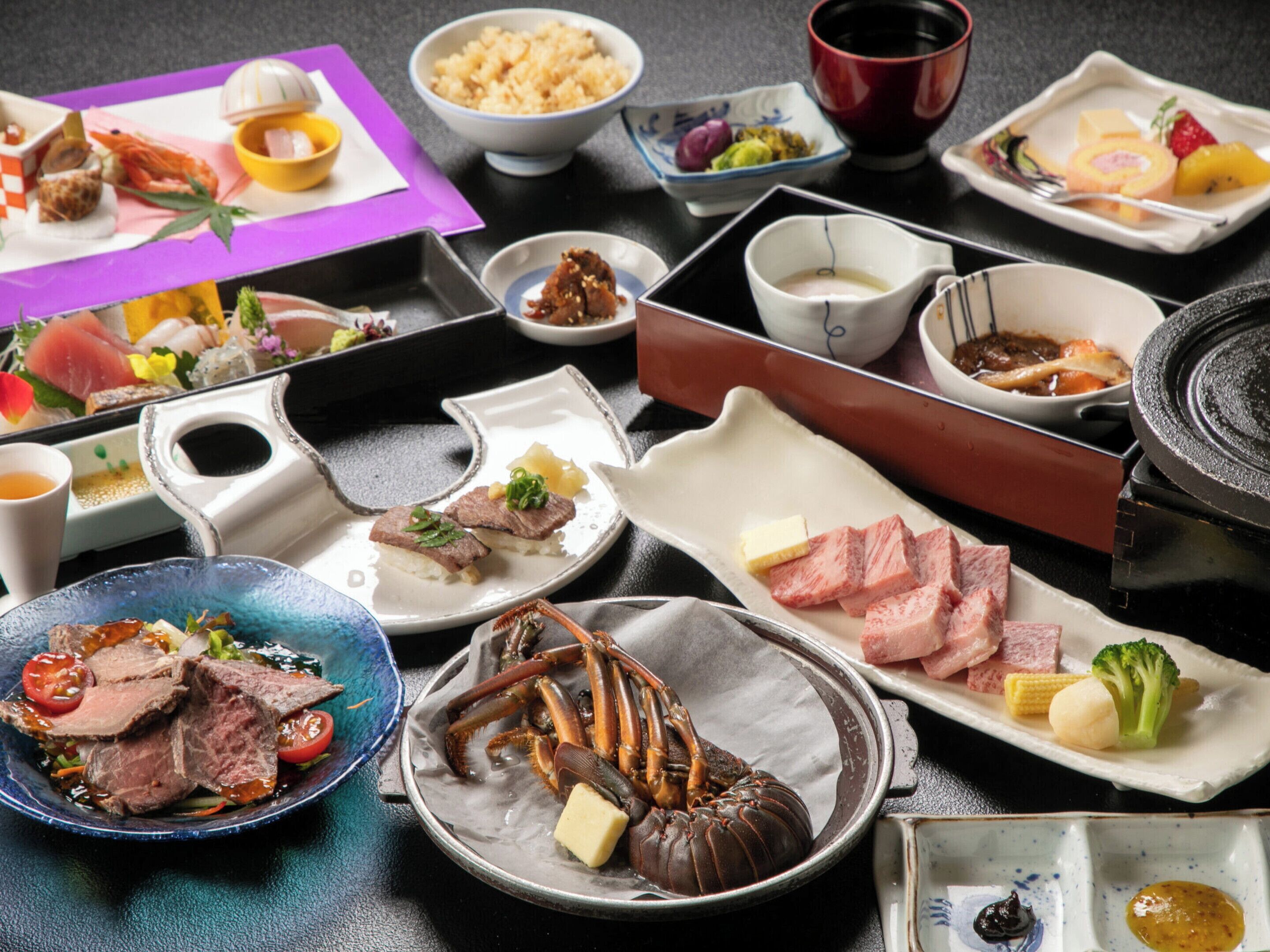 A variety of dishes on a table, including seafood, meat, and vegetables.
