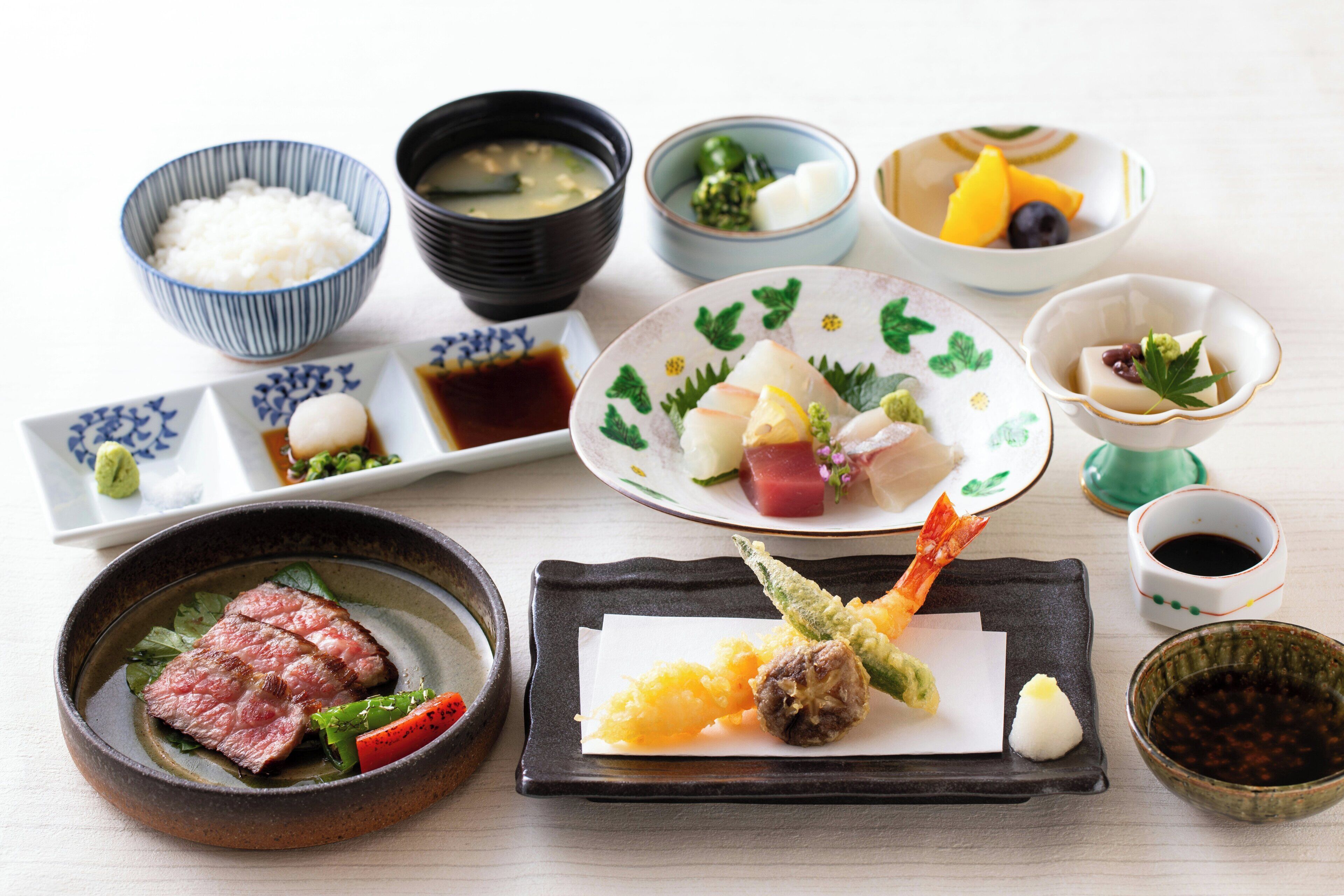 Diverse Japanse gerechten, waaronder sushi, sashimi en rijstkommen.