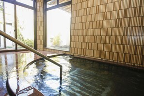 A hot spring area with a wooden wall and a metal railing. - Ako Park Hotel (Ako)