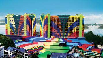 A multi-story hotel with colorful facades and a rooftop pool area.