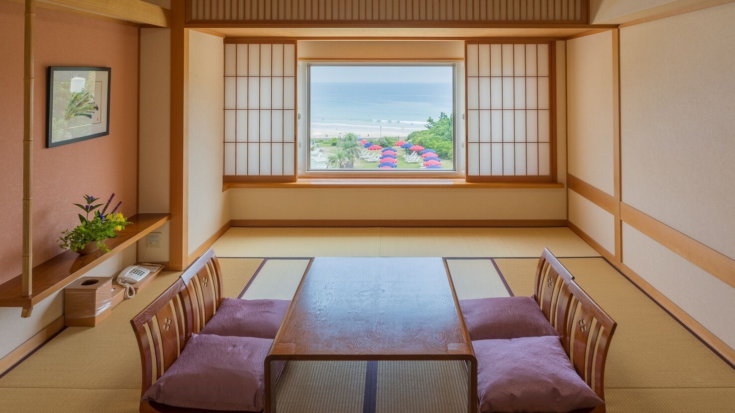 A traditional Japanese room with tatami flooring, a low table, and shoji screens.