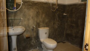 A bathroom with a sink, toilet, and shower. - Green Banana Mirissa (Mirissa)