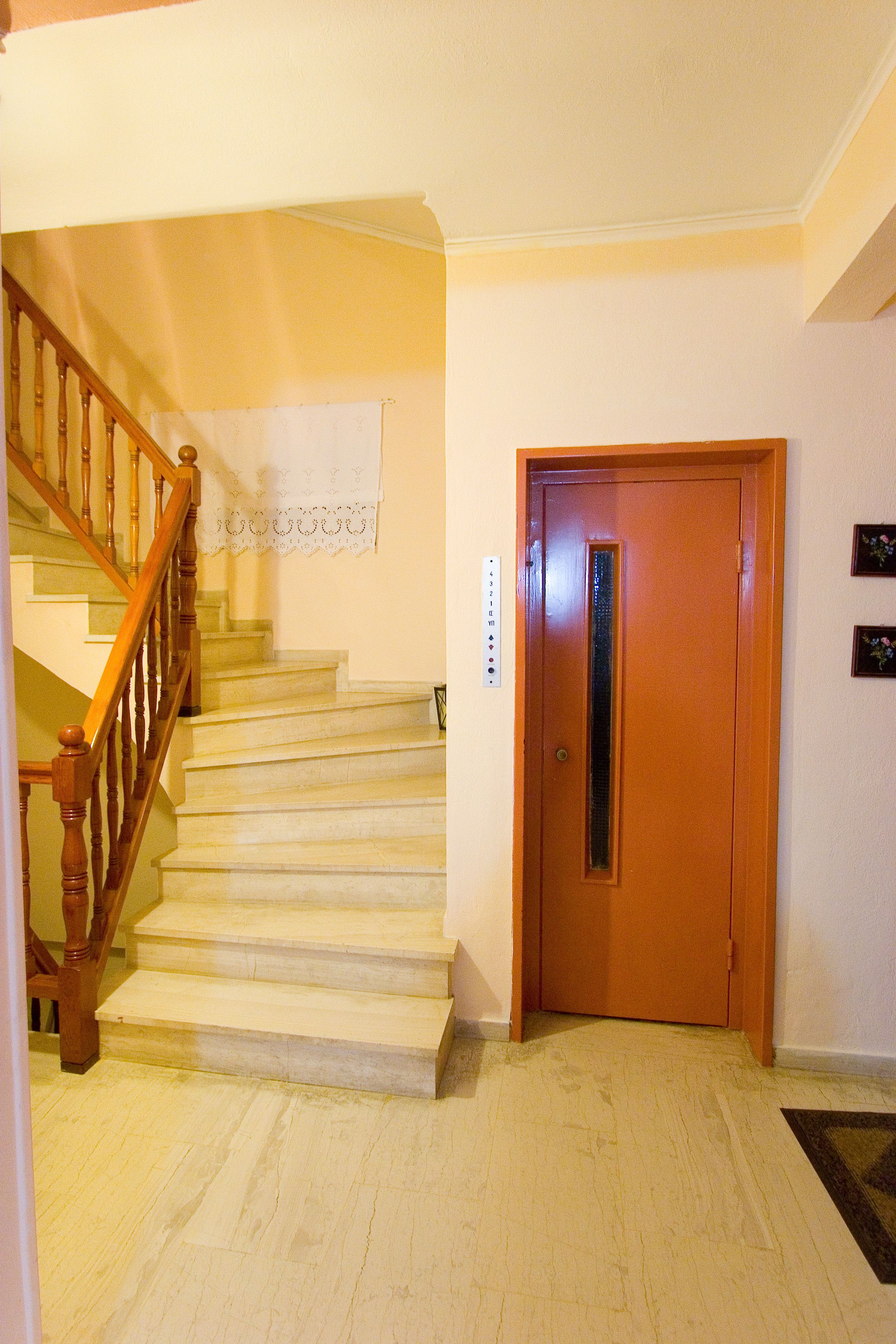 A staircase with wooden railings leading to a landing.