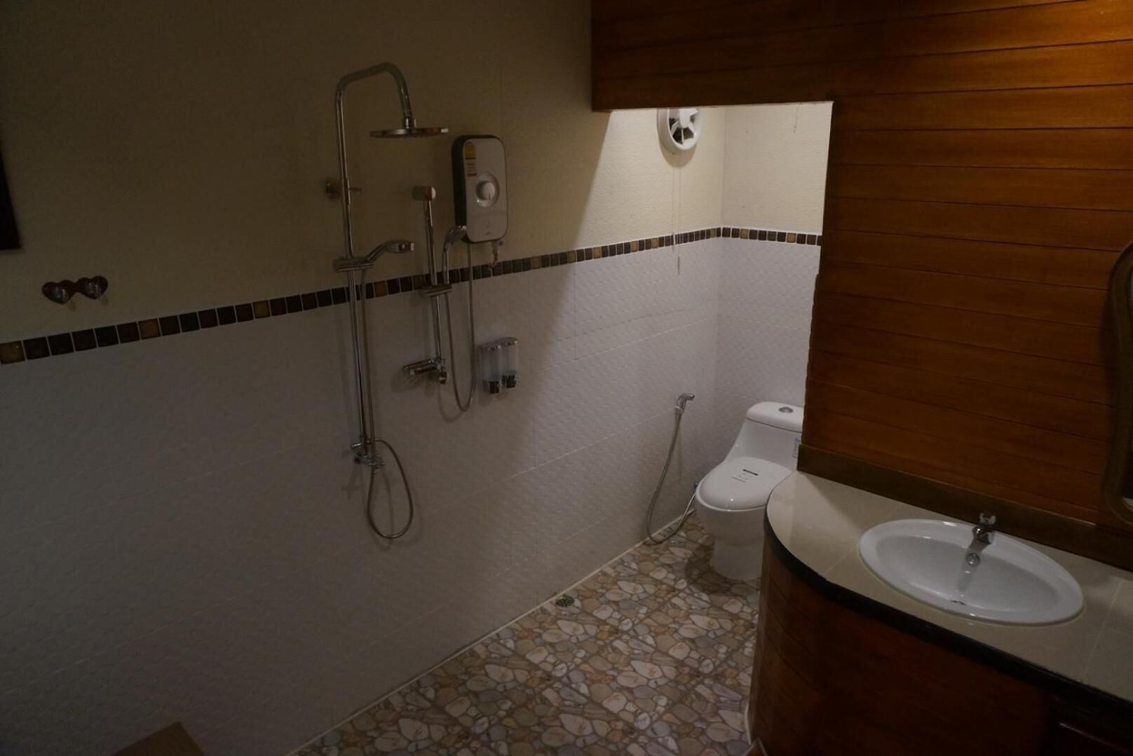 A bathroom with a shower, toilet, and sink.