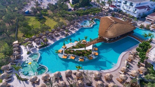 A resort with a large central pool, smaller satellite pools, and a circular water feature. - Letsos Hotel (Zakynthos)