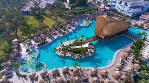 A resort with a large central pool, smaller satellite pools, and a circular water feature.