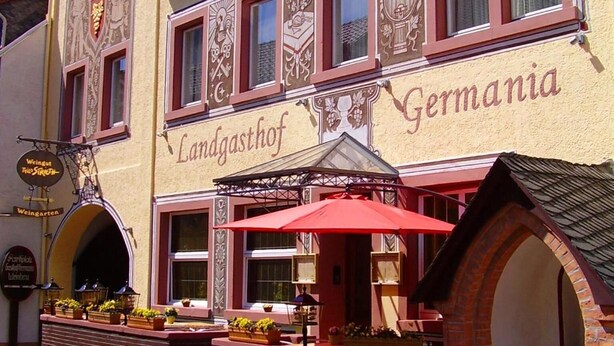 A building with the sign "Landgasthof Germania" and a red awning. - Landgasthof Germania (Ruedesheim am Rhein)
