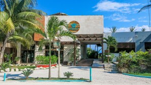 A modern building with a sign reading "Maria Del Mar" and a circular logo.