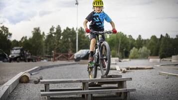 A person riding a bicycle on a wooden ramp.