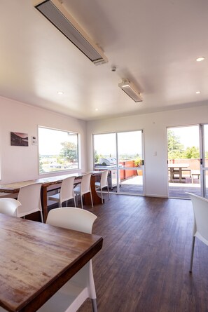 Enjoy meals at the dining table with views of the outdoors through large windows.
