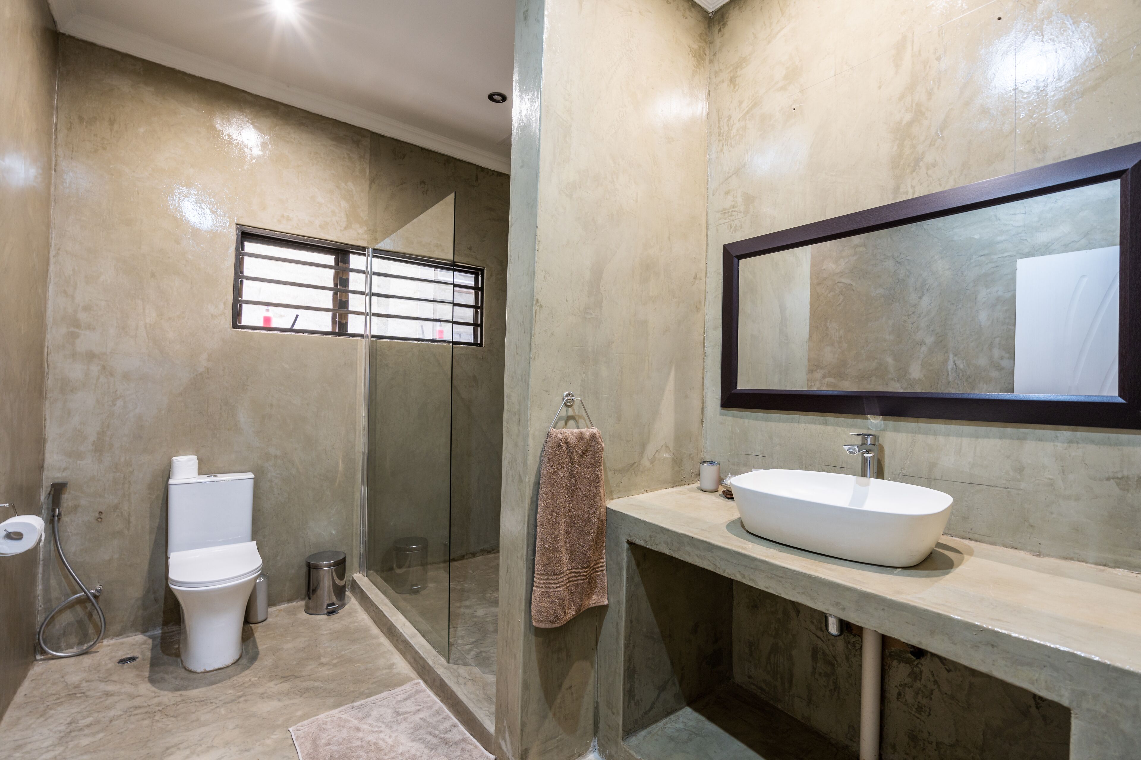 A bathroom with a toilet, sink, and shower.