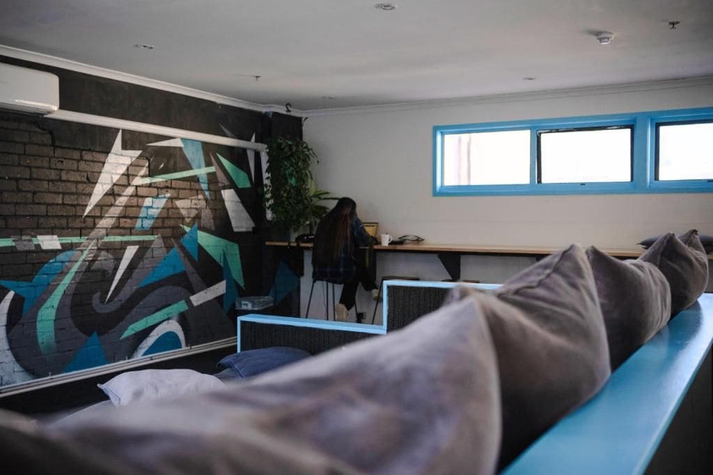 A room with a bed, a desk, and a window.
