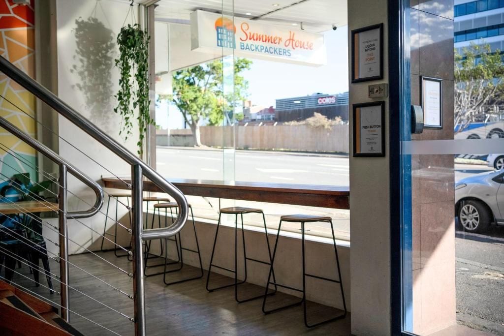 A staircase leading to a seating area with a view of the street outside.