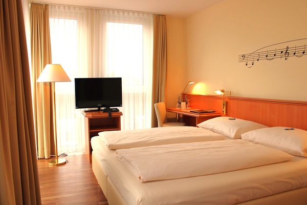 Hypo-allergenic bedding, desk, laptop workspace, blackout drapes